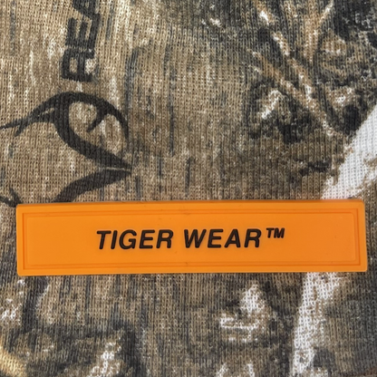 Close up of the orange PVC Tiger Wear label on the Woodland Pro Beanie