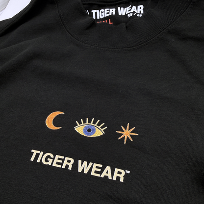 Close up of the chest print and neck label on a black Tiger Wear paintball tee