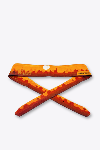 High Noon paintball headband by Tigerwear in orange desert sunset print, tied, showing the tapered tail