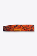 Opening Day paintball headband by Tigerwear in blaze orange leaf camo, laid flat with orange woven label