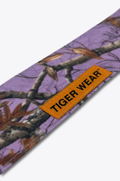 Close up of the orange woven Tiger Wear label on the Violet Hour headband, lavender tree camo