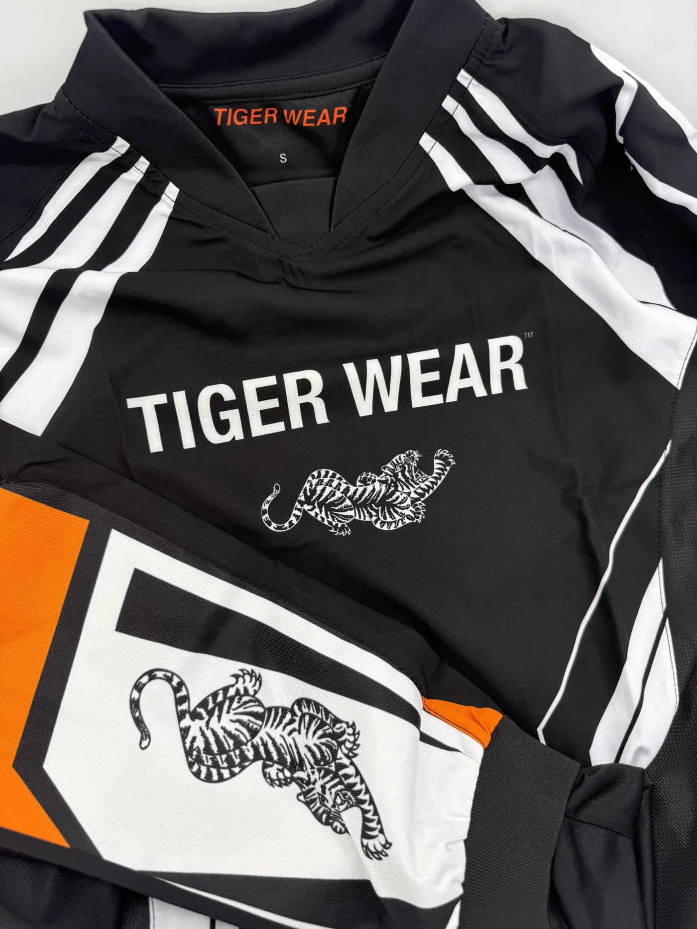 Practice Jersey collar, chest logo, and sleeve artwork